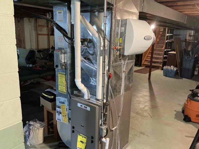 Conducted assessment of existing HVAC system in partially finished basement that doubles as a home gym. Recommended replacement of aging furnace unit with visible wear and outdated efficiency ratings. System requires new ductwork with proper insulation, PVC ventilation pipes, and installation of a humidifier component to improve air quality throughout the home.