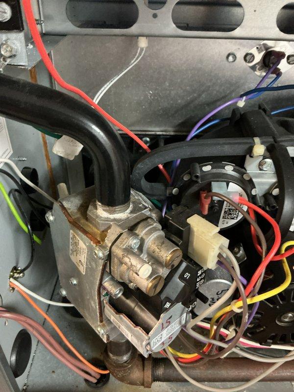 Performed comprehensive tune-up on Honeywell HVAC system, inspecting furnace interior components including blower motor, gas valve assembly, and electrical connections. Examined wiring integrity and connection points on the gas valve, noting normal wear but confirming proper functionality. All components were verified to be in working order with no significant issues detected.