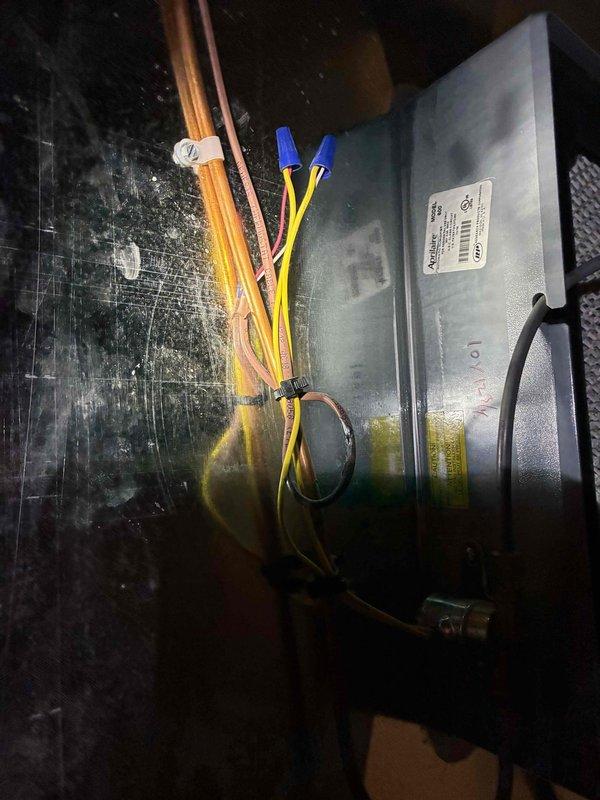 Responded to service call for HVAC system evaluation. Inspected electrical components and wiring connections in the air handler, noting proper installation of control board with intact wiring harnesses. Examined and cleaned humidifier assembly, confirming water distribution tube functionality and replacing mesh filter pad to ensure optimal humidity control performance.