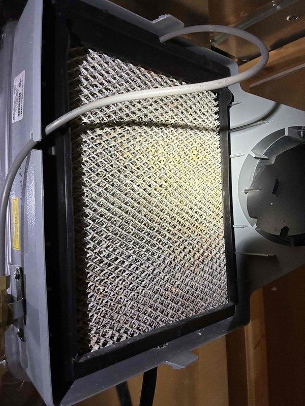 Responded to service call for HVAC system evaluation. Inspected electrical components and wiring connections in the air handler, noting proper installation of control board with intact wiring harnesses. Examined and cleaned humidifier assembly, confirming water distribution tube functionality and replacing mesh filter pad to ensure optimal humidity control performance.