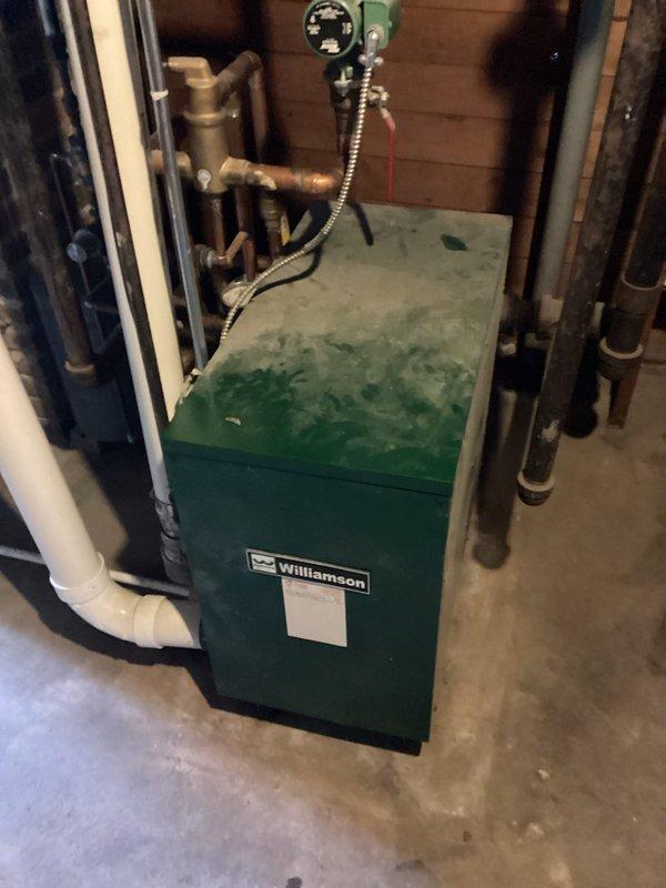 Responded to no-heat call for an aging Williamson heating system (10+ years old). Upon inspection of the unit in the basement utility area, identified and replaced a failed ignition control module and cleaned significant mineral deposits from the heat exchanger. System was tested after repairs with proper ignition sequence restored and normal operation confirmed.