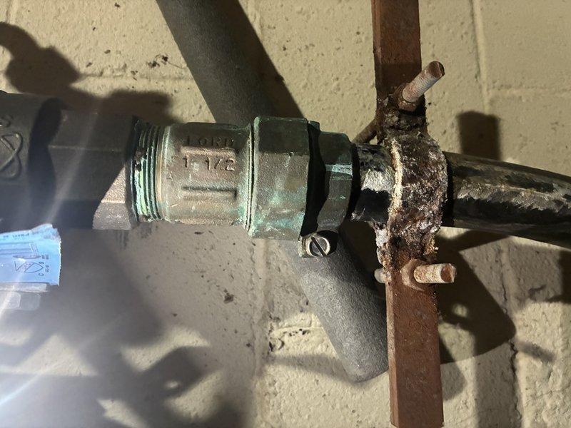 Replaced severely corroded brass pipe fitting on customer's faucet supply line. Identified significant mineral buildup and verdigris formation at threaded connection points. Installed new brass fitting to eliminate leak potential and restore proper water flow.