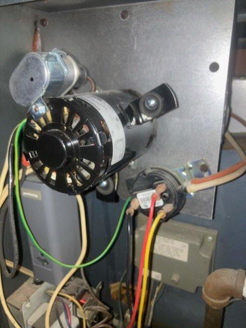 Responded to no heat call for unit less than 10 years old. Upon inspection, found failed blower motor preventing proper air circulation. Replaced motor assembly and verified all electrical connections (green, yellow, red, white wires) were properly secured. Tested system operation after repair, confirming proper ignition and airflow throughout the home. System now functioning normally with consistent heat production.