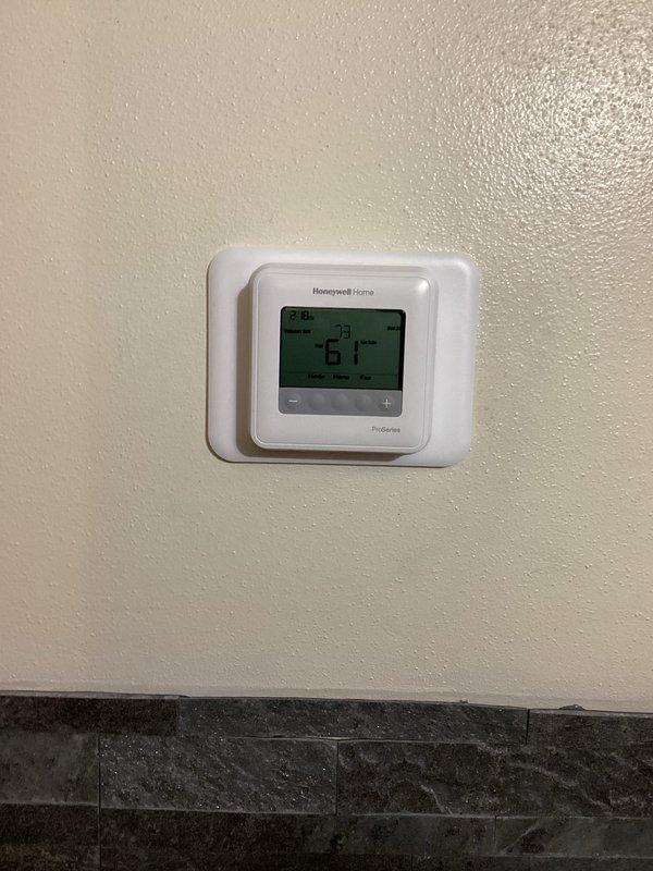 Successfully installed new furnace unit in basement area, including proper setup of condensate pump assembly with PVC drainage and connection of all electrical components. Verified system functionality with the newly installed Honeywell Home digital thermostat, confirming proper temperature display and operational controls.