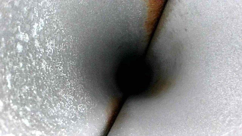 Performed routine inspection of HVAC ducting system. Visual examination revealed some minor discoloration and possible rust formation at duct seams. Photographed interior conditions for documentation purposes. System currently functioning within normal parameters despite noted cosmetic issues.