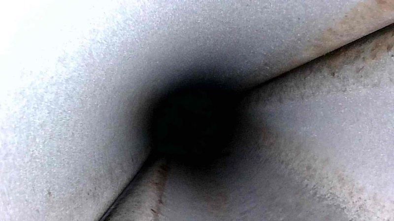 Performed routine inspection of HVAC ducting system. Visual examination revealed some minor discoloration and possible rust formation at duct seams. Photographed interior conditions for documentation purposes. System currently functioning within normal parameters despite noted cosmetic issues.