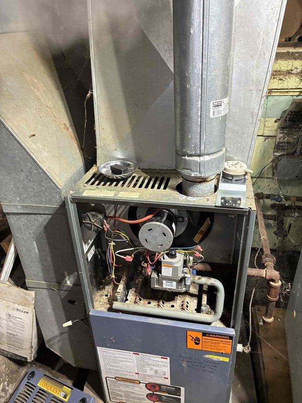 Performed diagnostic testing on aging furnace system showing no heat operation. Removed access panel to inspect internal components and identified faulty limit switch reading 27.1 ohms on multimeter. Replaced defective limit switch, cleaned accumulated dust from critical components, and verified proper ignition sequence. System now operating within manufacturer specifications with normal heat cycle.