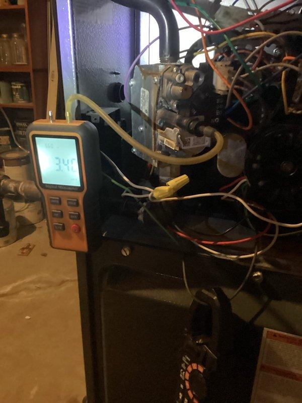 Diagnosed and repaired no-heat condition on aging furnace by testing gas valve with manometer, which revealed insufficient gas pressure (3.4" WC) causing intermittent flame failure. Adjusted gas valve regulator to manufacturer specifications, cleaned flame sensor, and verified proper operation through complete heating cycle test.