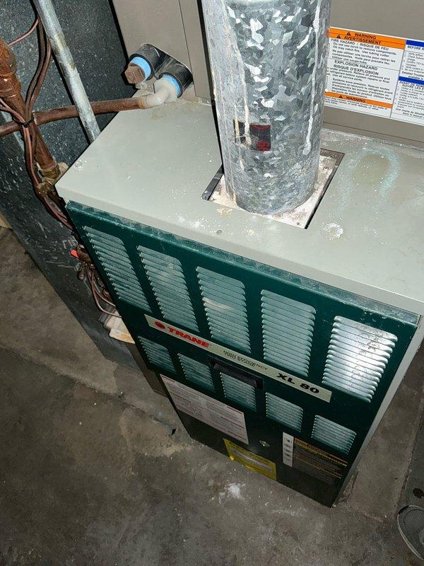 Conducted assessment of aging Trane XL 80 furnace system showing signs of moisture accumulation on top surface. Evaluated existing galvanized ductwork configuration including main trunk line, round connections and elbow joints. Prepared comprehensive replacement estimate for customer consideration.