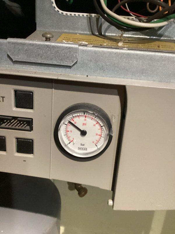 Performed diagnostic inspection on boiler system, checking pressure gauge readings and verifying proper operation. Examined control panel components including Honeywell controller and electrical connections. All systems operating within normal parameters with pressure readings in acceptable range.