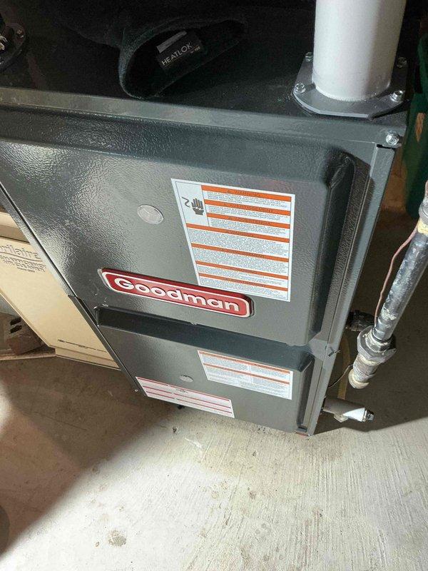 Responded to no heat call for Goodman HVAC system less than 10 years old. Diagnostics revealed induced draft motor failure with voltage reading of 10.69V (significantly below operational parameters). Replaced faulty motor, tested system operation through complete heating cycle, and verified proper combustion and exhaust venting through PVC flue pipe.