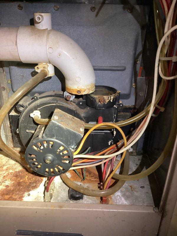 Diagnosed and repaired a furnace experiencing no-heat condition, finding significant corrosion at the condensate drain connection and yellowing of the PVC vent pipe. Replaced the corroded drain assembly and inspected the control board and gas valve connections, which showed signs of moisture exposure but remained functional. System now operating within normal parameters with proper heat output.