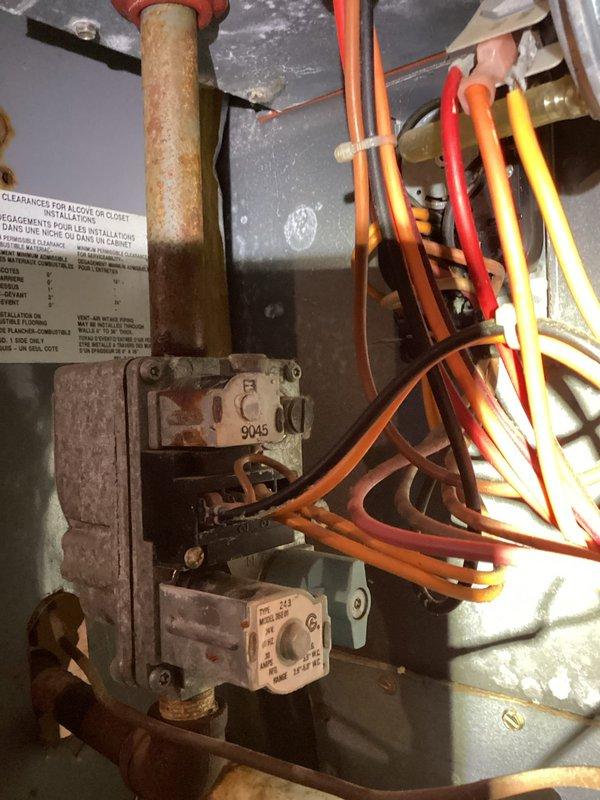 Diagnosed and repaired a furnace experiencing no-heat condition, finding significant corrosion at the condensate drain connection and yellowing of the PVC vent pipe. Replaced the corroded drain assembly and inspected the control board and gas valve connections, which showed signs of moisture exposure but remained functional. System now operating within normal parameters with proper heat output.