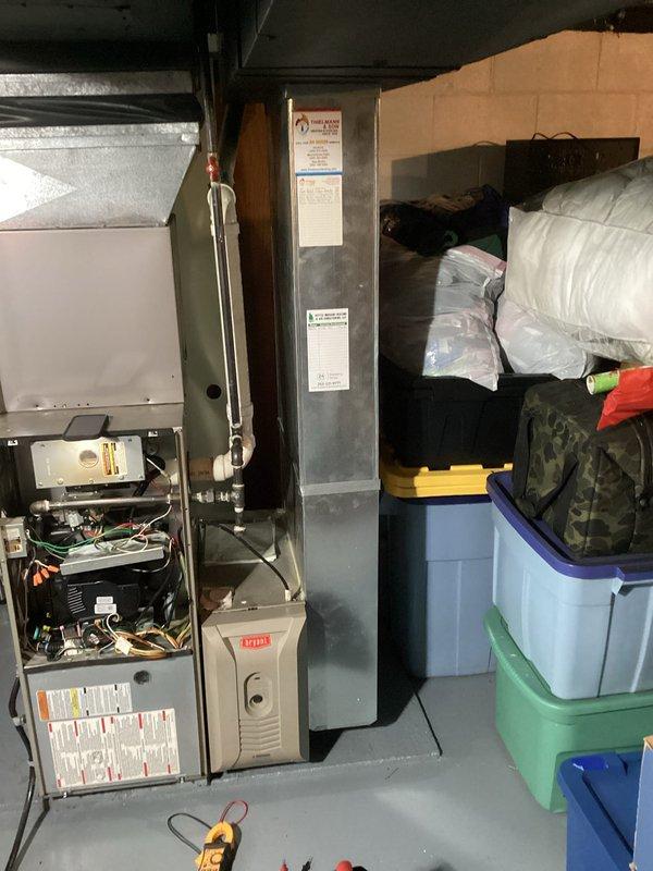 Responded to a no-heat call for a Bryant heating system under 10 years old. Upon inspection, accessed the furnace's internal components and examined the blower motor assembly, control board, and wiring connections. Discovered faulty wiring in the motor circuit which was preventing proper operation. Repaired damaged connections and verified system operation before closing access panel.