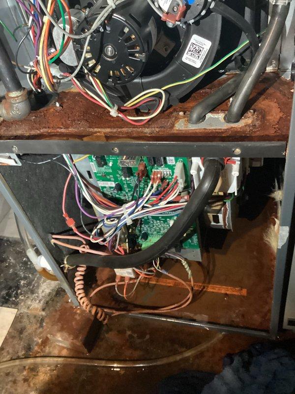 Performed diagnostic inspection on customer's furnace system, revealing significant rust and corrosion on internal metal components. Identified and replaced faulty blower motor and associated wiring harnesses that were showing signs of deterioration. Cleaned corroded connections on circuit board and verified proper system operation after repair.