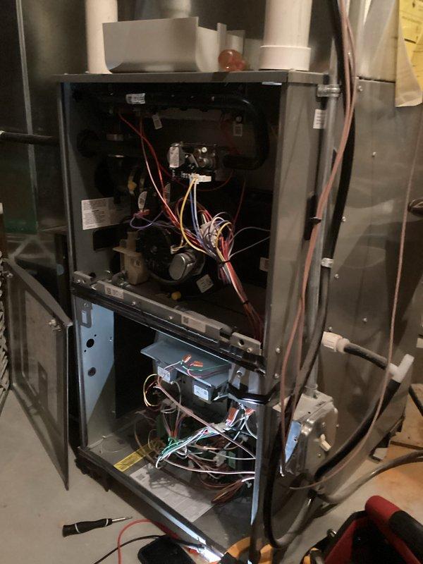Diagnosed electrical issues on aging furnace with clamp meter showing 122.3V. Accessed internal components by removing panels to inspect control board, blower motor assembly, and wiring connections. Identified and repaired faulty wiring in the control circuitry to restore proper heating function.