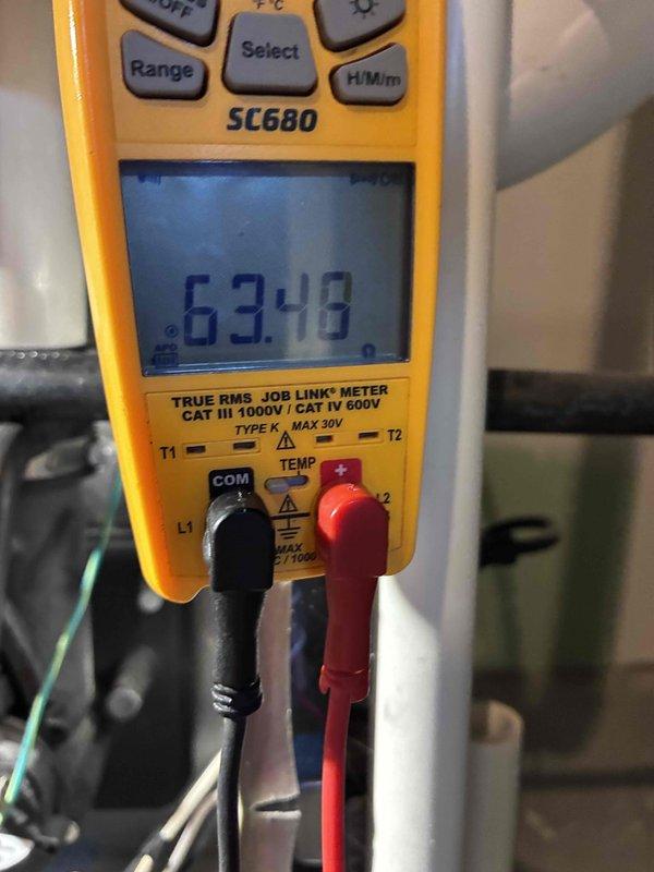 Performed routine HVAC maintenance service. Conducted diagnostic testing using Fieldpiece SC680 multimeter which showed reading of 63.48, and temperature measurements with UEI digital thermometer indicating 6.08°F. All system parameters verified within normal operating specifications.