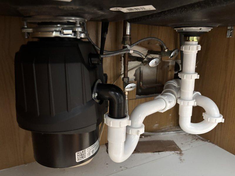 Completed installation of new kitchen faucet with proper connection to existing plumbing system. Installed and verified operation of garbage disposal unit, ensuring secure connections with PVC drainage pipes and P-trap assembly. All fixtures were tested for proper function and absence of leaks before completion.