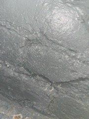 Responded to emergency call for water damage investigation. Identified water seepage through concrete foundation causing surface deterioration and staining. Applied temporary sealing measures to damaged area to prevent further moisture intrusion until permanent repairs can be completed.