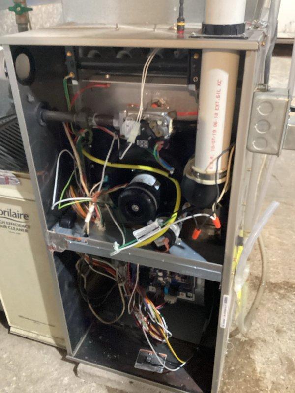 Performed routine tune-up maintenance on residential furnace system. Accessed internal components to inspect electrical connections and wiring integrity. Utilized hex key to adjust and secure mechanical components while verifying proper operation of the Honeywell control system. Checked blower motor assembly and confirmed all colored wiring connections were secure and properly terminated.