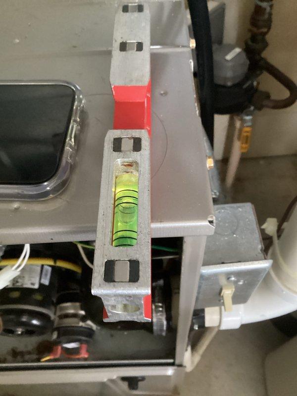 Completed tune-up service on HVAC system, verifying proper leveling of mounting bracket installation using built-in spirit level. Inspected plumbing connections including PVC, copper, and galvanized steel pipes, confirming all components were properly installed and functioning as designed.