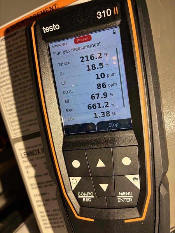 Performed combustion analysis on Lennox boiler system using Testo 310 II analyzer. Readings showed suboptimal efficiency at 67.9% with stack temperature of 216.2°F, oxygen at 18.5%, and CO2 at 1.38%. Documented existing installation configuration in mechanical room for reference.