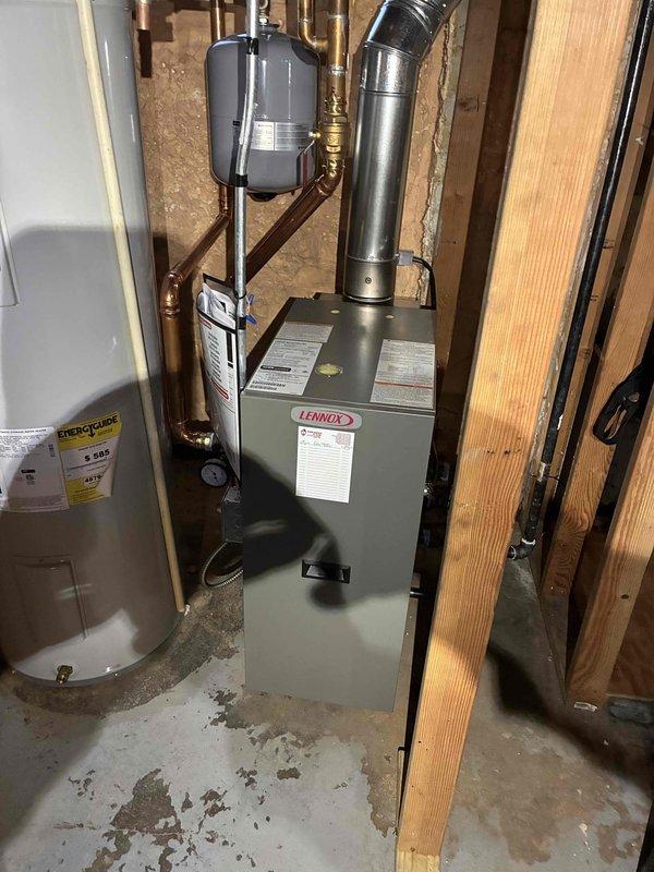 Performed combustion analysis on Lennox boiler system using Testo 310 II analyzer. Readings showed suboptimal efficiency at 67.9% with stack temperature of 216.2°F, oxygen at 18.5%, and CO2 at 1.38%. Documented existing installation configuration in mechanical room for reference.