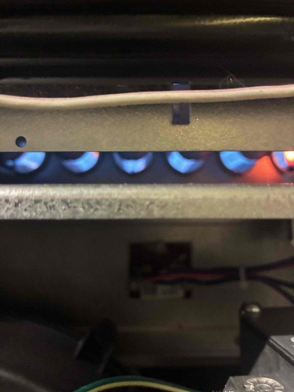 Performed scheduled prepaid maintenance on HVAC system. Inspected and cleaned ductwork, verifying proper UV light installation and functionality. Examined furnace burners, noting consistent blue flame pattern with one burner showing orange/red flame requiring adjustment for optimal combustion efficiency.