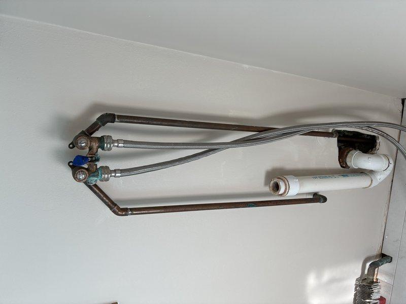Conducted comprehensive inspection of existing plumbing configuration featuring copper supply lines with visible aging and potential minor corrosion at joints. System includes braided stainless steel flexible connectors to valve fixtures and PVC integration. Documented current condition of ceiling-mounted assembly for future reference and maintenance planning.