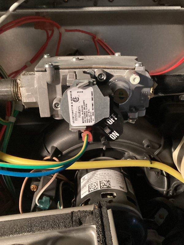 Responded to no-heat call for Carrier system less than 10 years old. Diagnosed faulty gas valve preventing proper ignition. Replaced gas valve assembly, reconnected all electrical connections (red, blue, green, yellow wires), and verified proper operation of blower motor. System now functioning correctly with normal heating cycle restored.