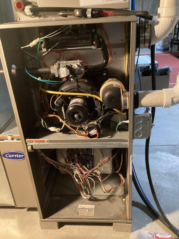 Responded to no-heat call for Carrier system less than 10 years old. Diagnosed faulty gas valve preventing proper ignition. Replaced gas valve assembly, reconnected all electrical connections (red, blue, green, yellow wires), and verified proper operation of blower motor. System now functioning correctly with normal heating cycle restored.