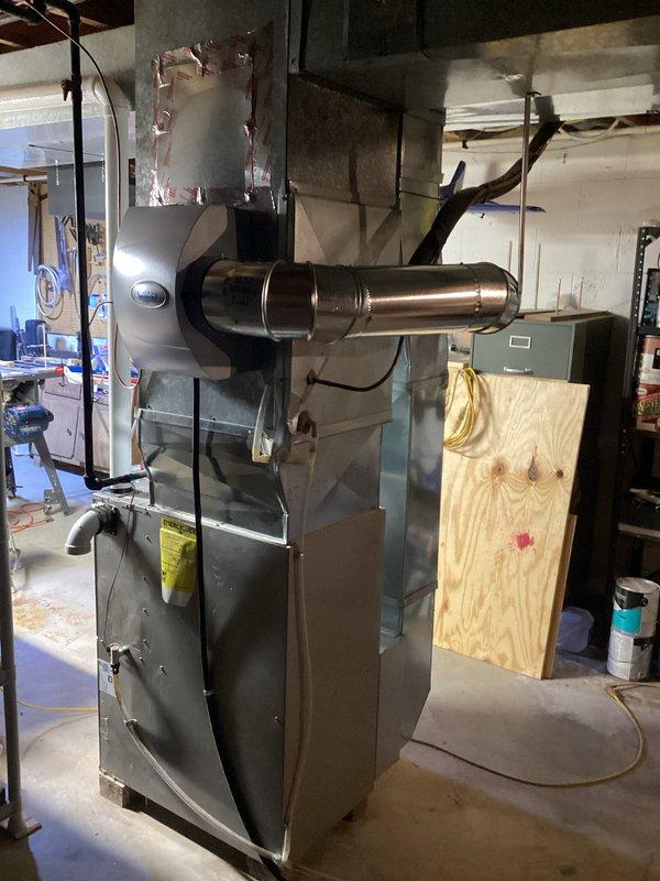 Completed installation of an AprilAire humidifier system on existing HVAC unit in basement utility room. Mounted humidifier to side of air handler with proper ductwork connections including winter panel (#35) installation. Verified all electrical connections and ensured proper integration with existing furnace system for optimal indoor air quality control.