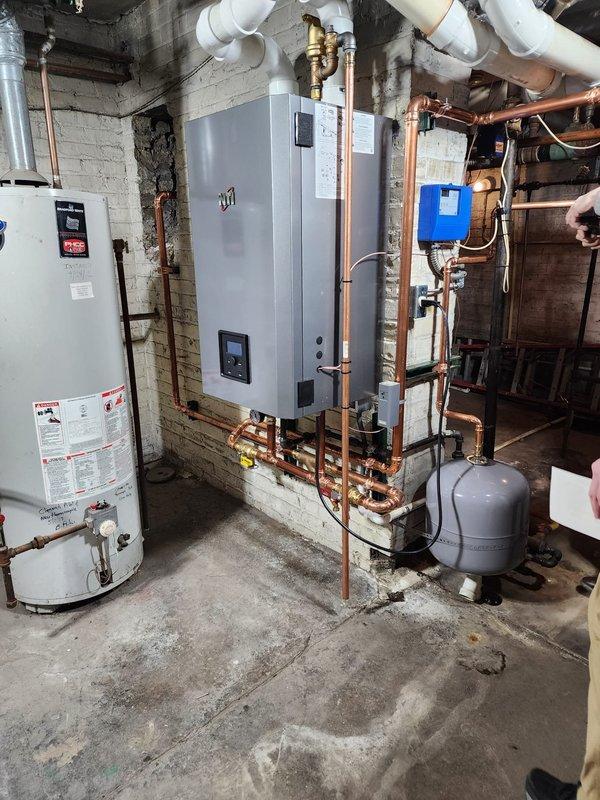 Successfully installed new high-efficiency boiler system in basement utility room, including complete copper piping network with brass fittings and valves. Integrated digital control panel and circulation pump with all necessary components, including expansion tank and PVC venting. System was tested and verified for proper operation.