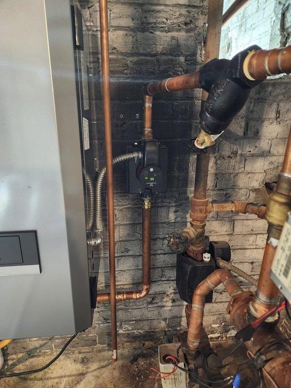 Successfully installed new high-efficiency boiler system in basement utility room, including complete copper piping network with brass fittings and valves. Integrated digital control panel and circulation pump with all necessary components, including expansion tank and PVC venting. System was tested and verified for proper operation.