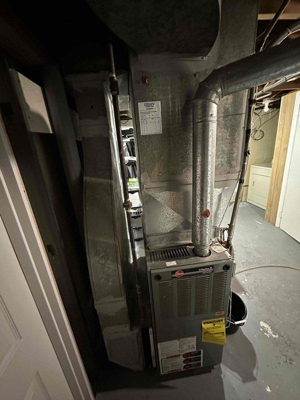 Conducted comprehensive assessment of existing HVAC system and electrical service panel. Documented Rheem furnace installation with connected ductwork and exhaust ventilation in utility area. Verified electrical panel configuration and wiring connections to ensure compatibility with proposed replacement system.