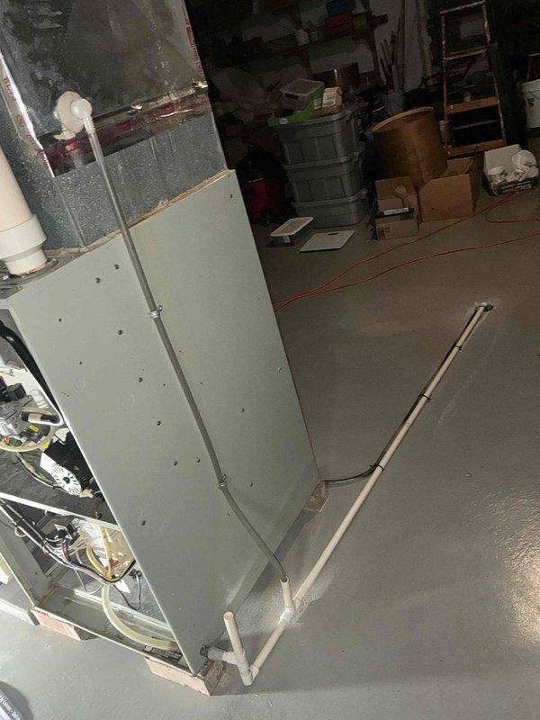 Conducted an assessment of an existing HVAC system in basement utility area, documenting a Pioneer unit with dual PVC ventilation pipes. Evaluation included inspection of the furnace cabinet, internal wiring components, drainage system, and connection points in preparation for replacement recommendation.