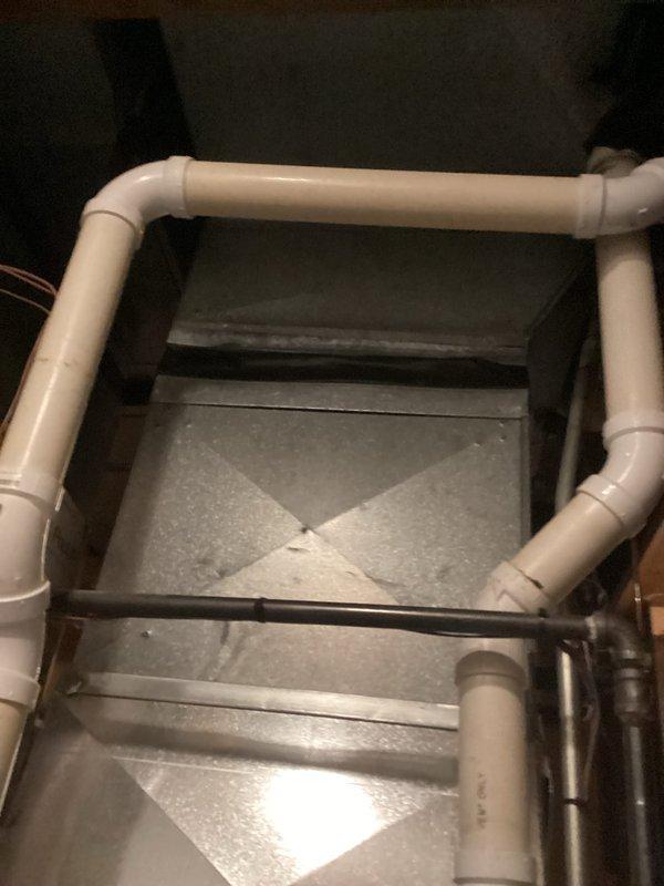 Completed routine tune-up of HVAC system and identified moisture issues in the utility area. Inspected PVC drainage pipes which were found to be properly installed with no visible damage or leaks; however, noted standing water on concrete floor near electrical cables which requires further investigation to prevent potential hazards and system damage.