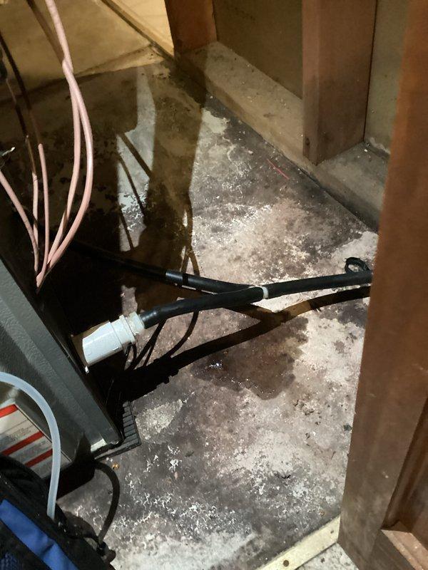 Completed routine tune-up of HVAC system and identified moisture issues in the utility area. Inspected PVC drainage pipes which were found to be properly installed with no visible damage or leaks; however, noted standing water on concrete floor near electrical cables which requires further investigation to prevent potential hazards and system damage.