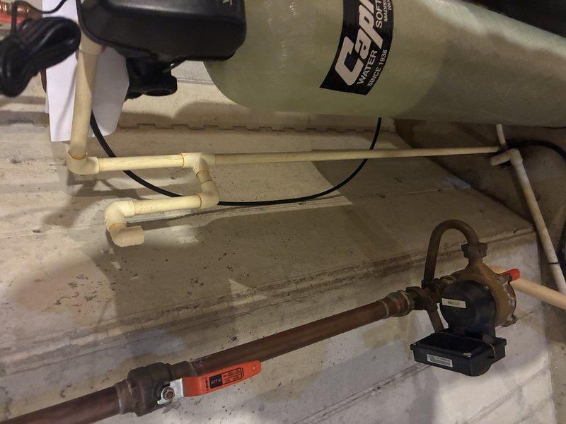 Installed new Capri water softener/filtration system in utility area, connecting to existing copper plumbing with appropriate shut-off valves. Set up complete drain line configuration using PVC piping and connected system to electrical supply. Tested system operation to ensure proper functionality.
