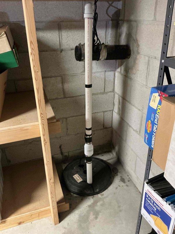 Installed new sump pump system in basement, including vertical PVC discharge pipe with proper connections. System was mounted securely to concrete block wall with all necessary components for effective water removal. Verified proper operation before completion.