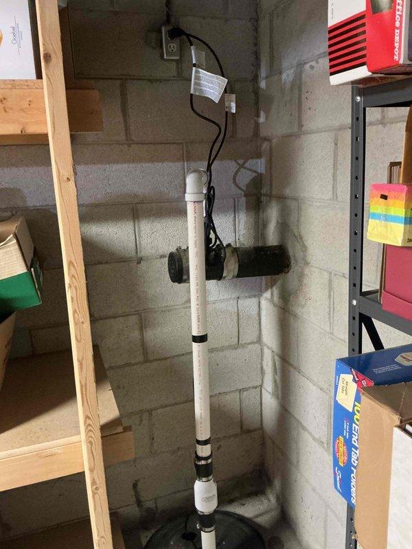 Installed new sump pump system in basement, including vertical PVC discharge pipe with proper connections. System was mounted securely to concrete block wall with all necessary components for effective water removal. Verified proper operation before completion.