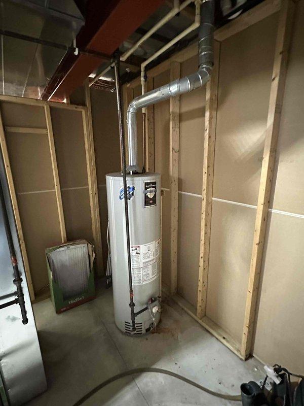Completed installation of a new Lennox furnace system with proper ductwork connections in unfinished basement utility room. Installed new water heater with appropriate metallic ventilation piping, ensuring proper integration with existing mechanical infrastructure. Both units were properly secured and connected to the home's utility systems with all necessary ventilation components in place.