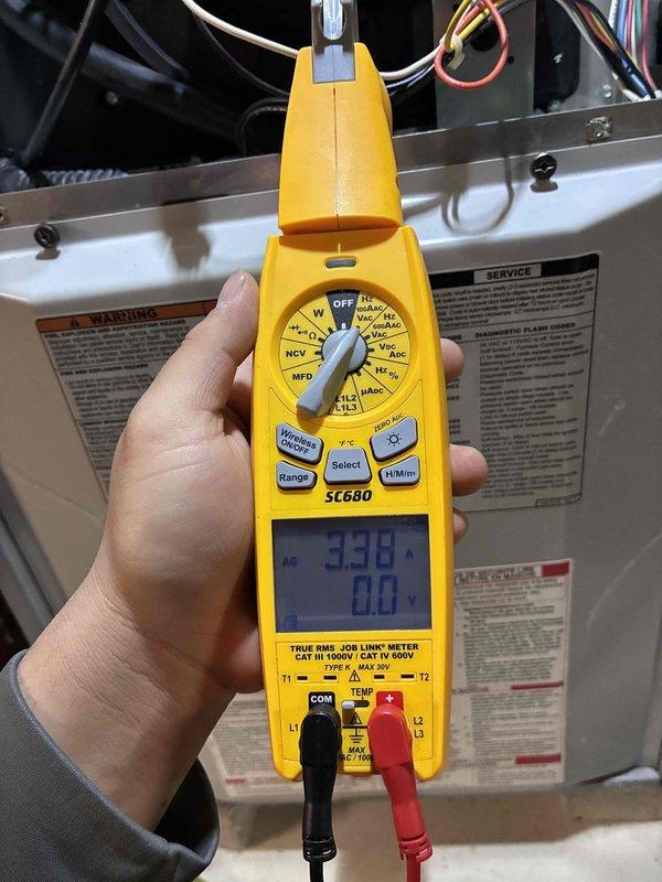 Performed routine HVAC tune-up service, including electrical diagnostic testing with SC680 clamp meter showing nominal voltage readings of 3.36A. Inspected and verified proper connections of motor assembly wiring, confirming all terminal connections were secure with no signs of wear or damage to the green ground wire and multicolored control wires (red, yellow, white).