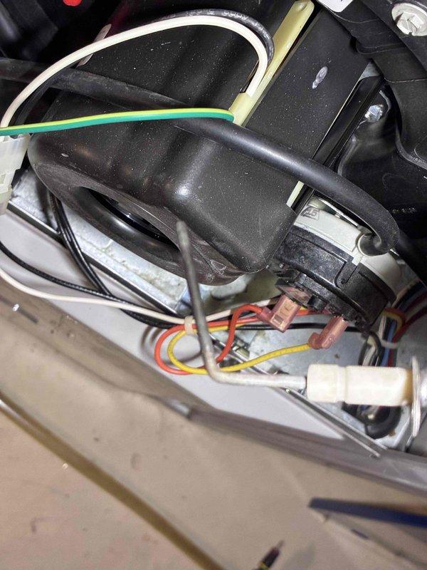 Performed routine HVAC tune-up service, including electrical diagnostic testing with SC680 clamp meter showing nominal voltage readings of 3.36A. Inspected and verified proper connections of motor assembly wiring, confirming all terminal connections were secure with no signs of wear or damage to the green ground wire and multicolored control wires (red, yellow, white).