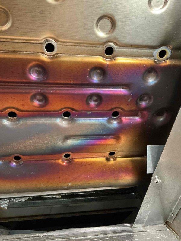 Conducted routine prepaid maintenance service on HVAC system. Inspected heat exchanger which showed normal heat discoloration patterns with iridescent coloring typical of proper operation. Verified integrity of metal components and confirmed all mounting hardware was secure.