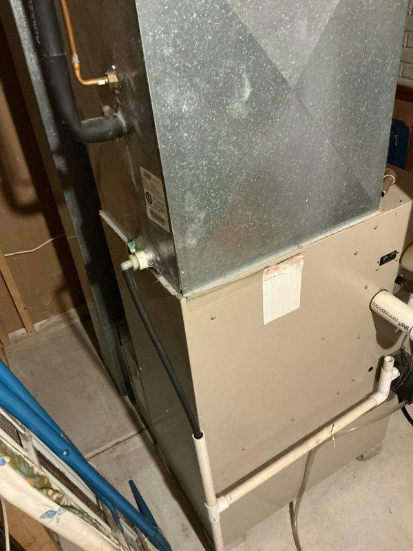 Performed comprehensive assessment of existing HVAC system located in utility area, noting installation configuration with galvanized ductwork connections and PVC ventilation components. Inspected electrical panel to verify appropriate circuit capacity for potential replacement unit, confirming proper labeling and accessibility of dedicated HVAC breakers.