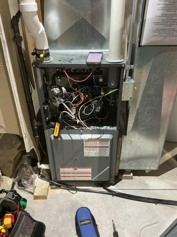 Performed comprehensive furnace tune-up including inspection of internal components, electrical connections, and control boards. Removed front panel to access and test safety systems and electronic controls. Examined ventilation system including PVC exhaust pipes and verified proper installation of ductwork connections. All systems operating within normal parameters after service.