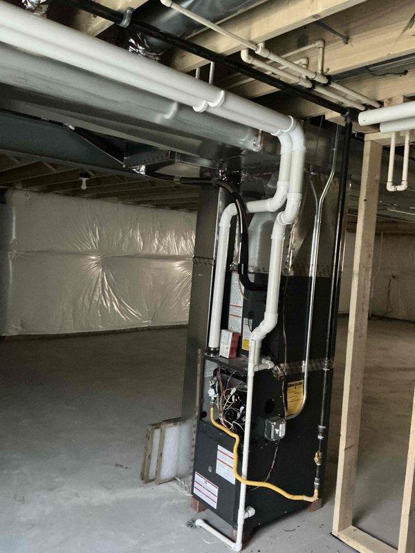 Conducted comprehensive assessment of basement HVAC system, focusing on indoor air quality factors. Inspected exposed ductwork throughout unfinished basement area and evaluated the furnace unit with associated PVC ventilation piping. Documented existing vapor barrier installation and ventilation pathways for potential IAQ improvement recommendations.