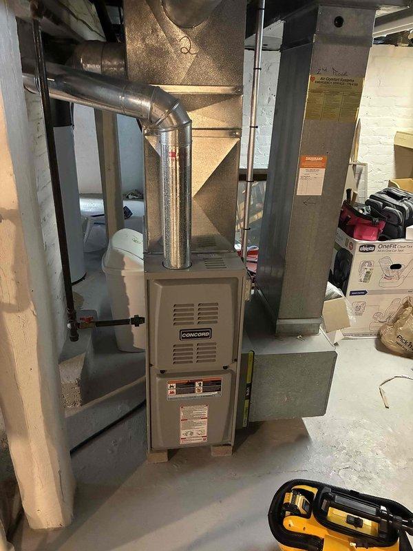 Performed routine tune-up on Concord furnace system located in basement utility room. Inspected burner assembly and verified proper blue flame pattern across all burners, indicating complete combustion. Checked all ductwork connections and system components for proper installation and operation.