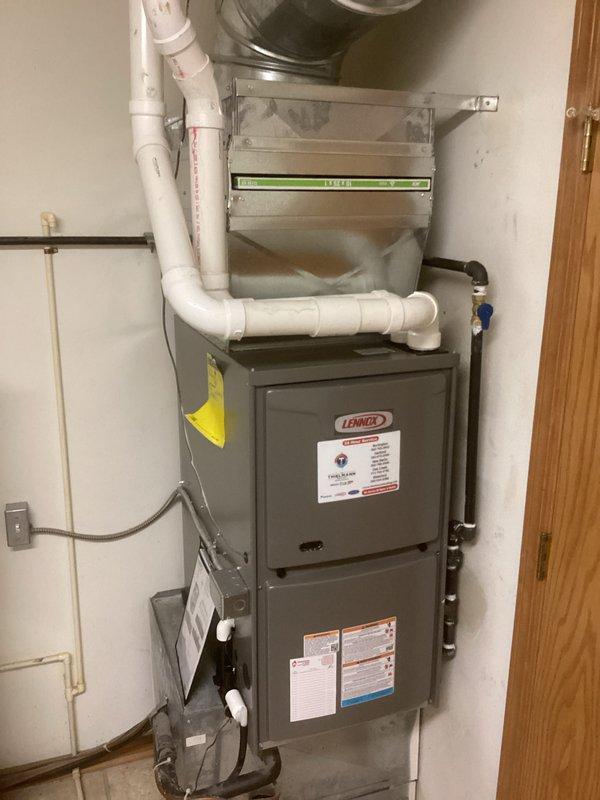 Successfully installed a new Lennox furnace unit in the utility area, including proper connection of PVC ventilation pipes and electrical components. System includes integrated air filtration with all manufacturer specifications followed and safety labels properly affixed.